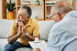 depressed man in therapy thinking about what to say next
