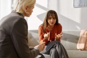 women speaking to therapist about medication